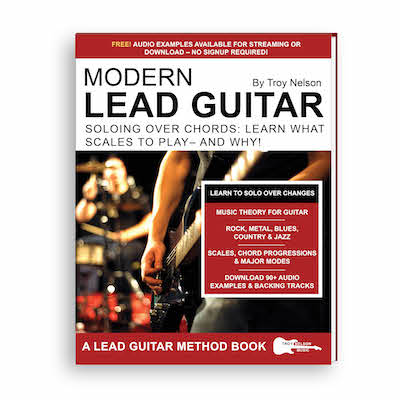 man playing a rock guitar on stage